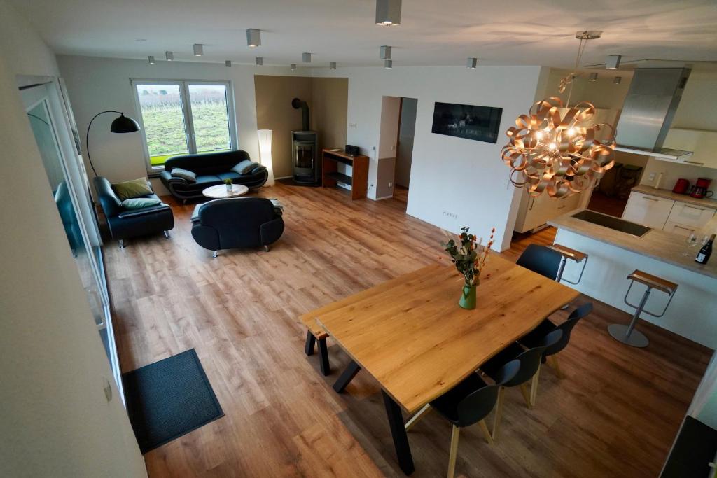 Una vista aérea de una sala de estar y cocina con una mesa de madera. en Ferienhaus Rebenhof, en Neustadt an der Weinstraße