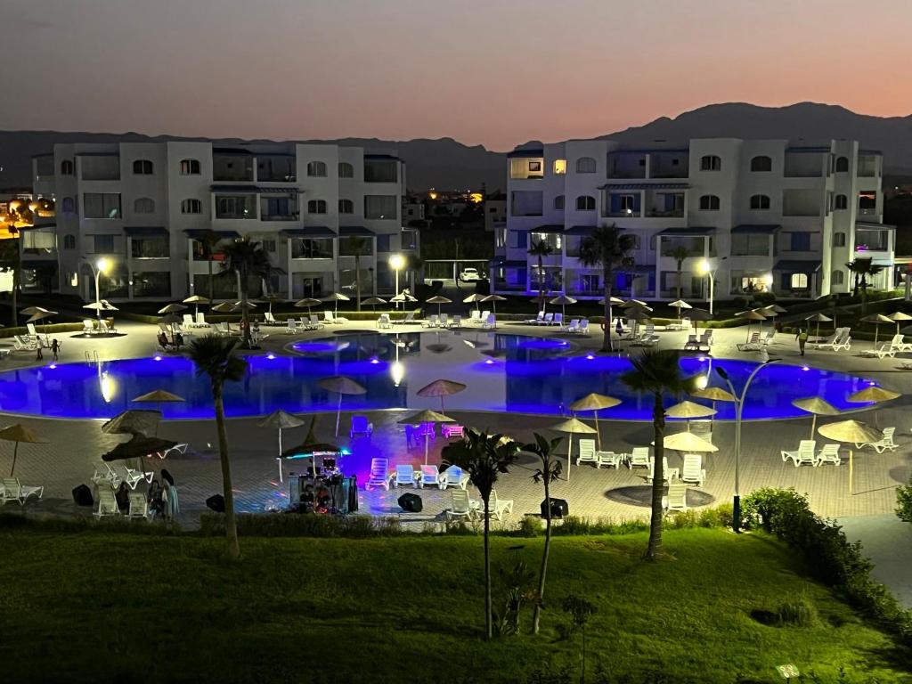 a large pool with blue lights in front of buildings at Mirador Capo Negro in Cabo Negro