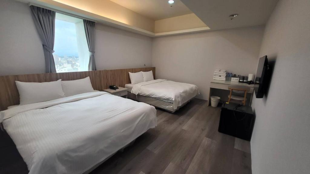 Rúm í herbergi á Xingyi Hotel