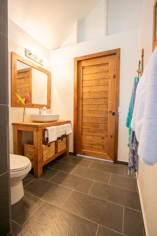 a bathroom with a sink and a toilet at Sol Bungalows Bocas del Toro in Bocas del Toro