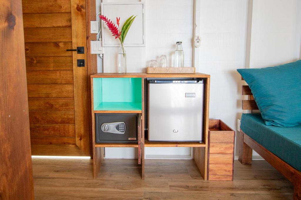 a tv on a stand next to a couch at Sol Bungalows Bocas del Toro in Bocas del Toro