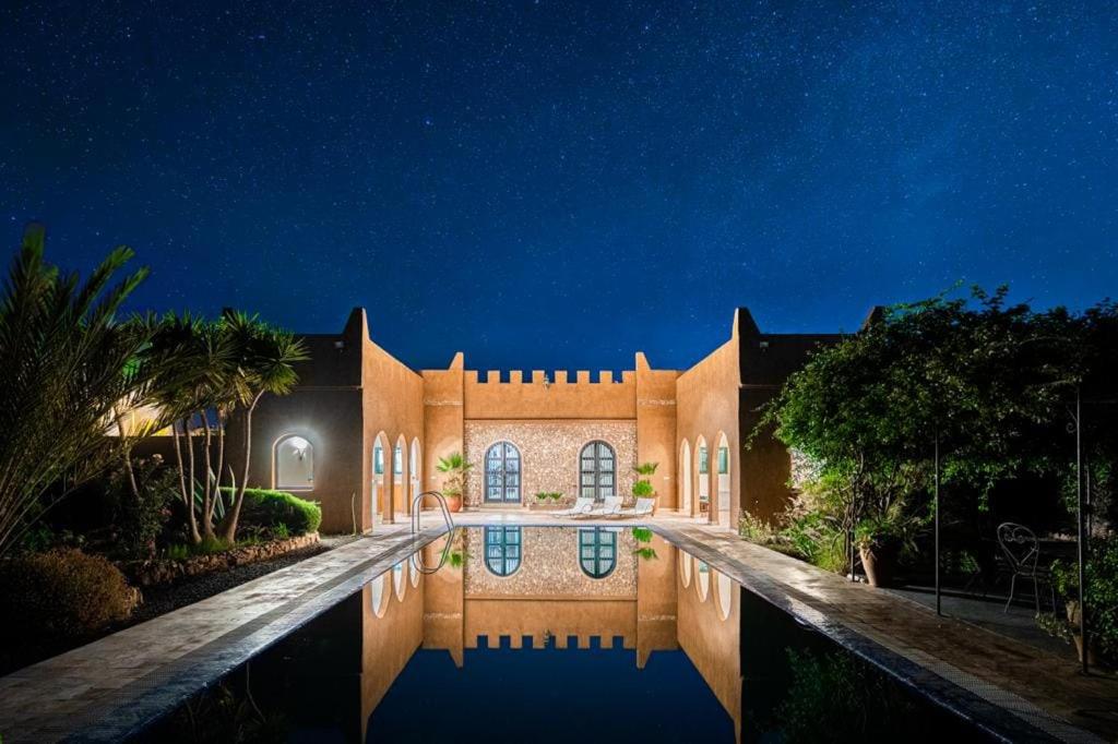 a house with a swimming pool at night at Luxury Spot 2026 - Riad Sahara Experience - Piscine in Imalalene