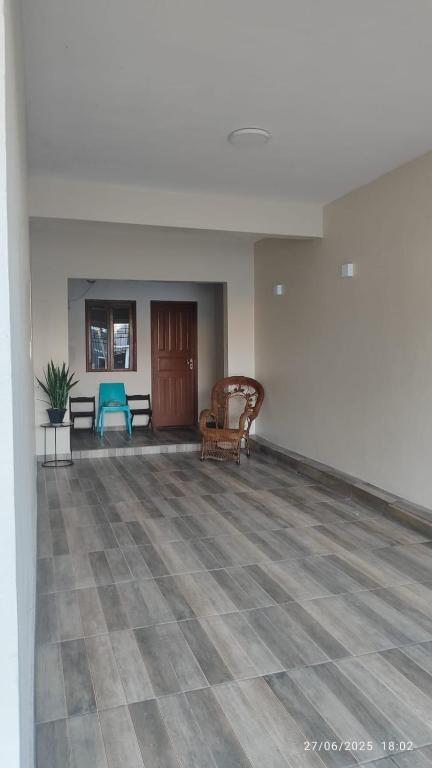 an empty room with a couch and a chair at Studio Figueira, Casa in Santarém