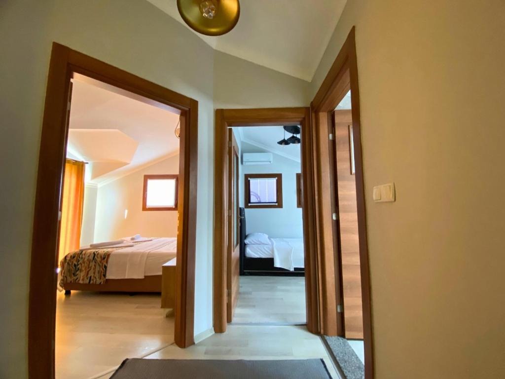 a room with a bedroom with a bed and a mirror at Sea View Fethiye in Fethiye