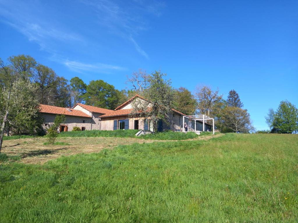 a house on a hill with a green field at La Férandie in Chéronnac