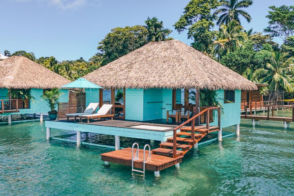 a house on the water with a dock in the water at Sol Bungalows Bocas del Toro in Bocas del Toro