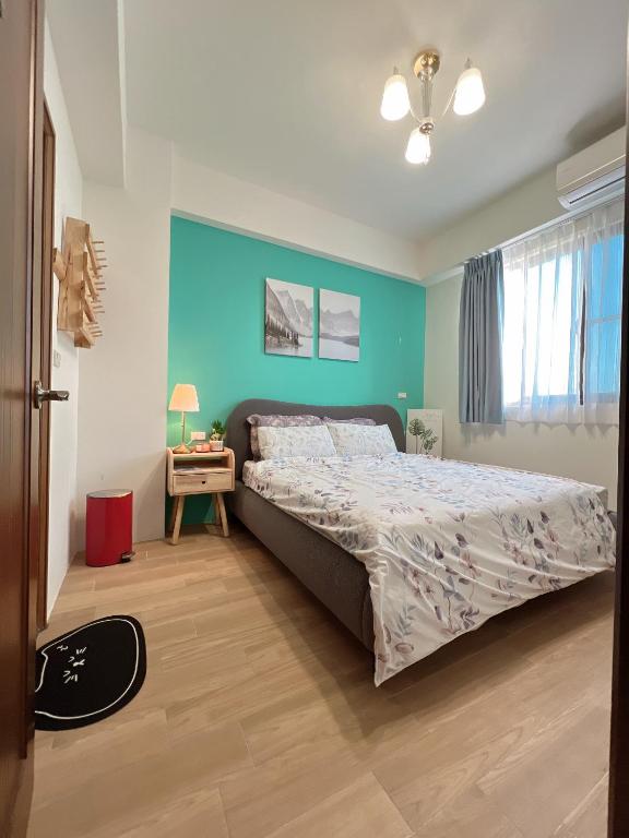 a bedroom with a bed and a blue wall at Beautiful Villa in Shanhua