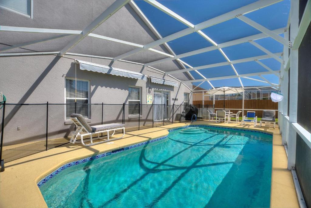 a large swimming pool with a retractable roof at Family Villa Destination in Davenport