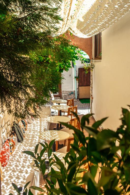 an outdoor patio with tables and chairs and plants at Casa Fiore in Seferihisar