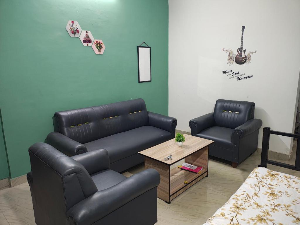 a living room with two chairs and a couch at Nirmali Homestay in Guwahati