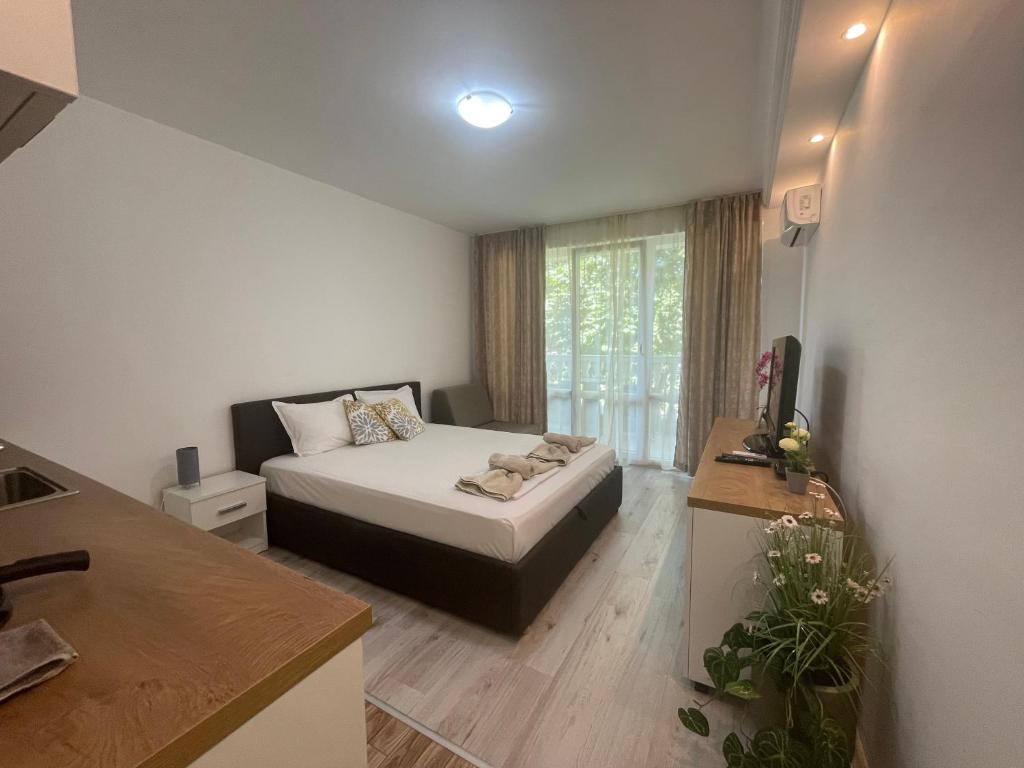 a small bedroom with a bed and a window at Студио Симона 3 - първа линия море in Lozenets
