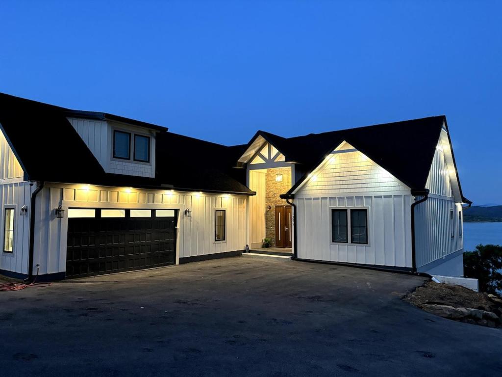 a large white house with a garage at Exclusive Lakefront Retreat on Douglas Lake in Dandridge