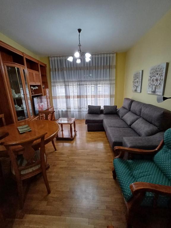 a living room with a couch and a table at Apartamento la Costa in Colunga
