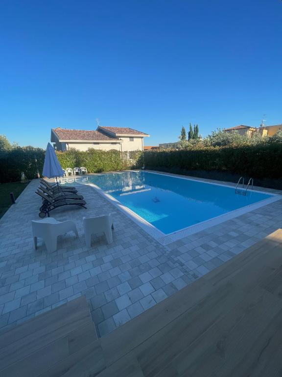 a swimming pool with chairs and a house at A casa di Ale in Lanciano