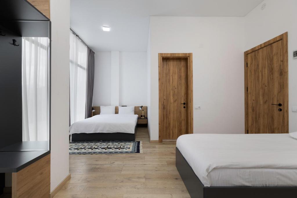 Postel nebo postele na pokoji v ubytování 3100 Boutique Hotel Kazbegi