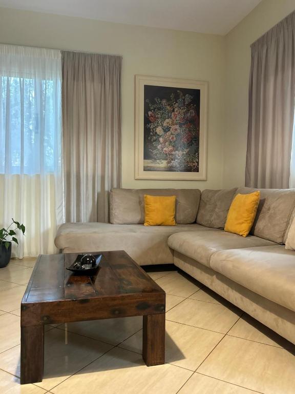 a living room with a couch and a coffee table at Marina Oasis Apartments in Vlorë