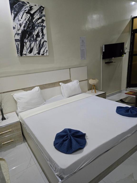 Ένα ή περισσότερα κρεβάτια σε δωμάτιο στο Résidence Teranga walo