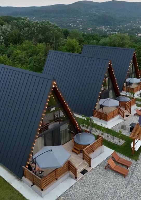 an overhead view of a house with a roof with picnic tables at Mareva House A Frame Chalet in Râmnicu Vâlcea