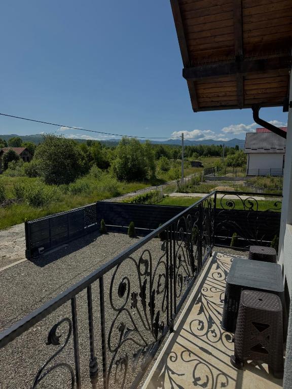 a balcony with a bench and a view at La Pop Cu Drag in Ocna Şugatag