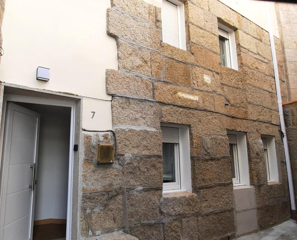 a brick building with a door and windows at Casa Saballa in O Grove