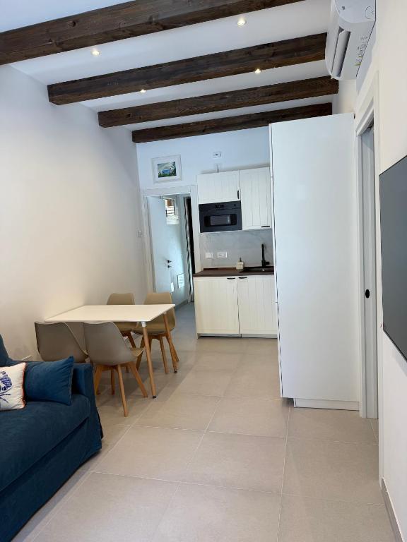 a living room with a blue couch and a table at Cervia Mare in Cervia