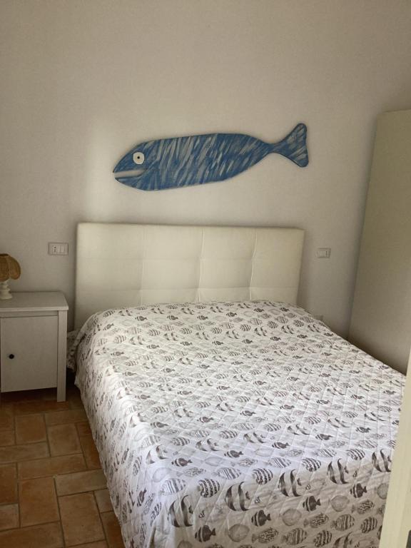 a bedroom with a bed with a fish on the wall at Casa VITTORIA in Procchio