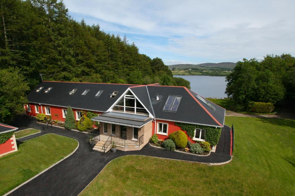 an aerial view of a house with a lake at The Lodge @ Harvey's Point in Donegal