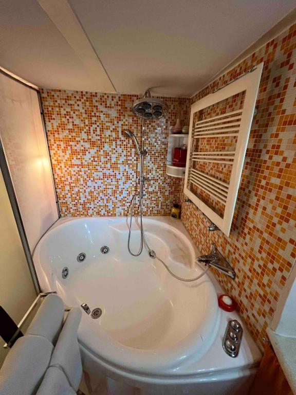a bathroom with a large tub in a room at Grand Tour Suite Home in Spoleto