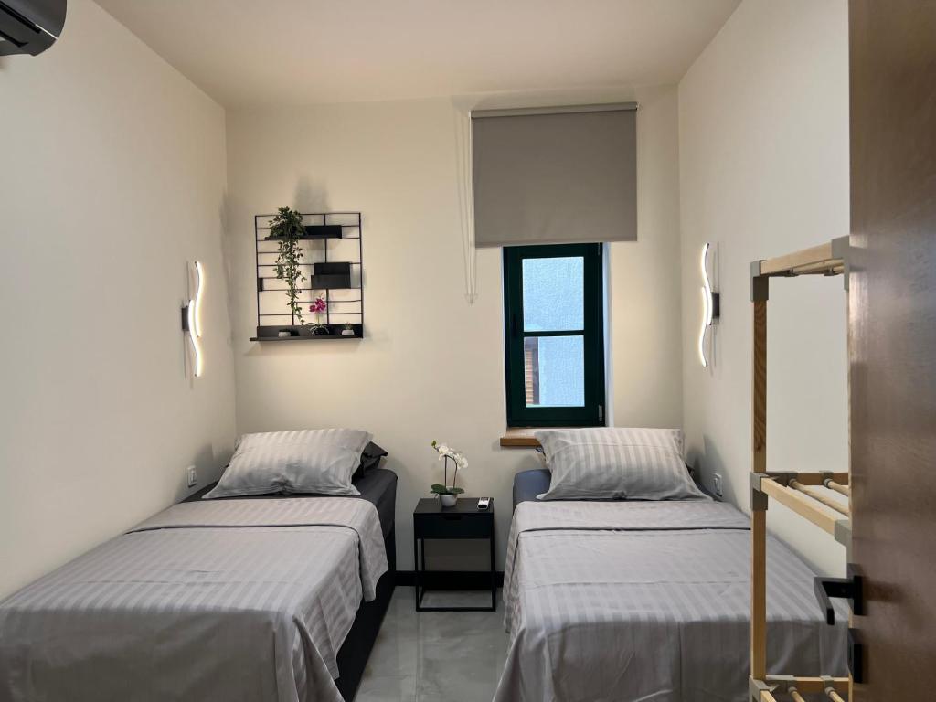 a room with two beds and a window at Villa Central in Crikvenica