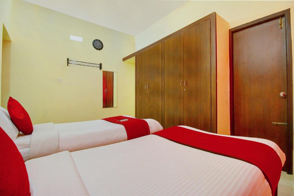 Postel nebo postele na pokoji v ubytování Super Hotel O Infosys Thoraipakkam