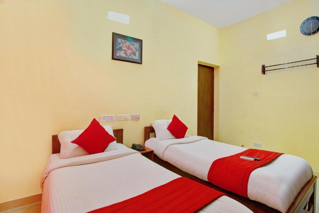 Postel nebo postele na pokoji v ubytování Super Hotel O Infosys Thoraipakkam