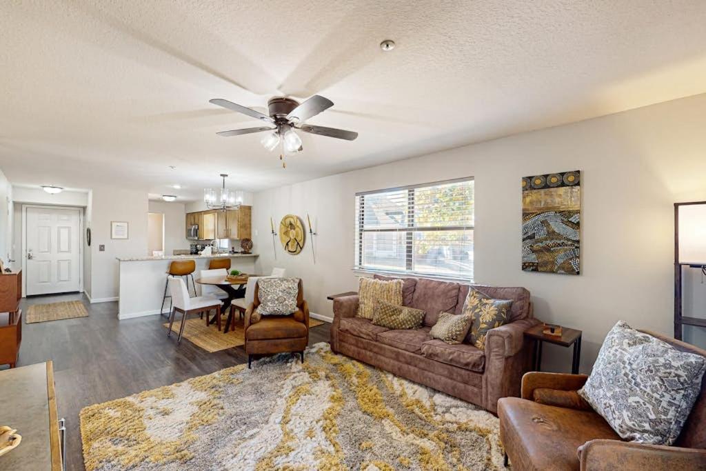 a living room with a couch and a ceiling fan at Silver Linings at Pointe Royale in Branson