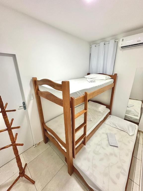 a small room with two bunk beds in it at Quarto 06 - Pousada Canaã in Recife