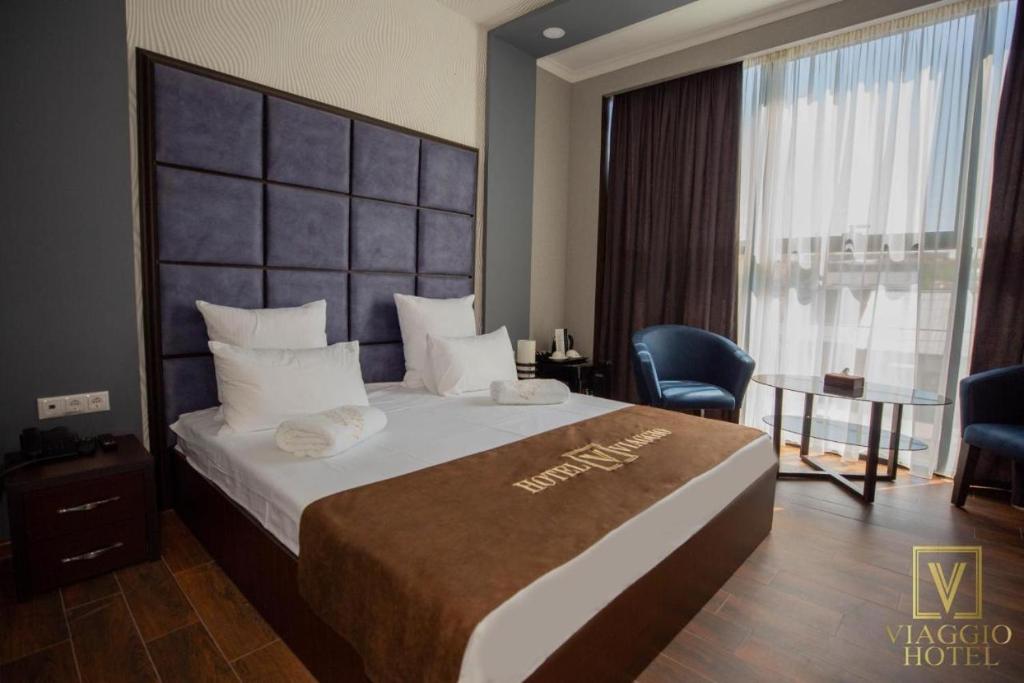 Postel nebo postele na pokoji v ubytování WIAGGO Hotel & Tours