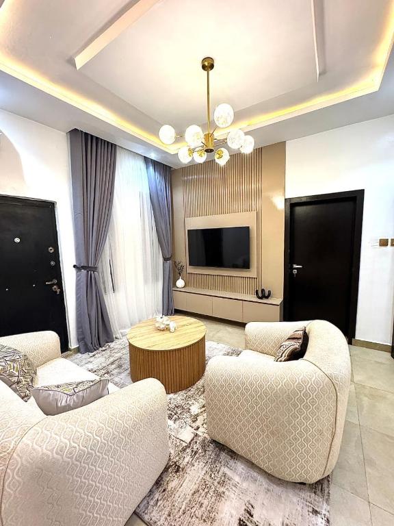 a living room with two couches and a television at Sohana Homes in Ikeja