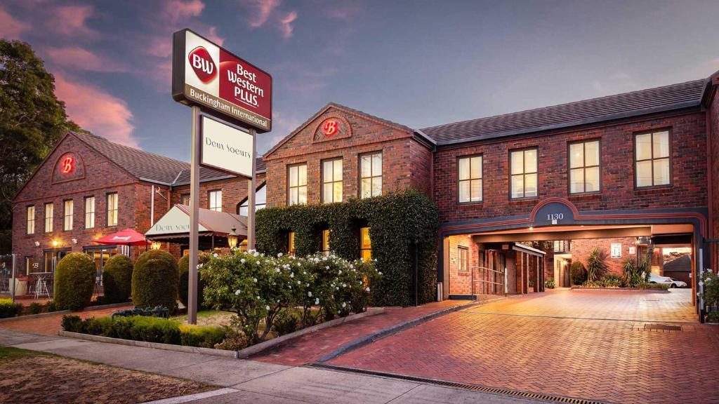 a building with a sign in front of it at Best Western Plus Buckingham International in Moorabbin