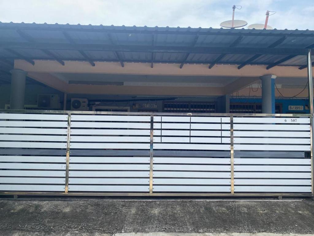 a white fence in front of a stadium at Ariniz Homestay Beserah in Beserah