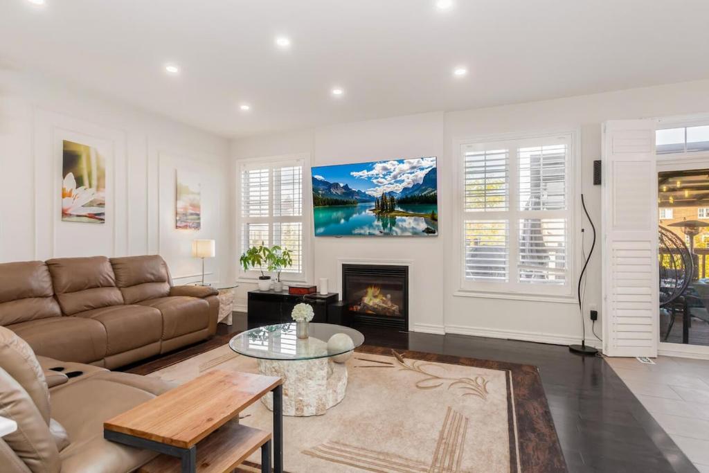 a living room with a couch and a fireplace at Excellent luxury living in Milton