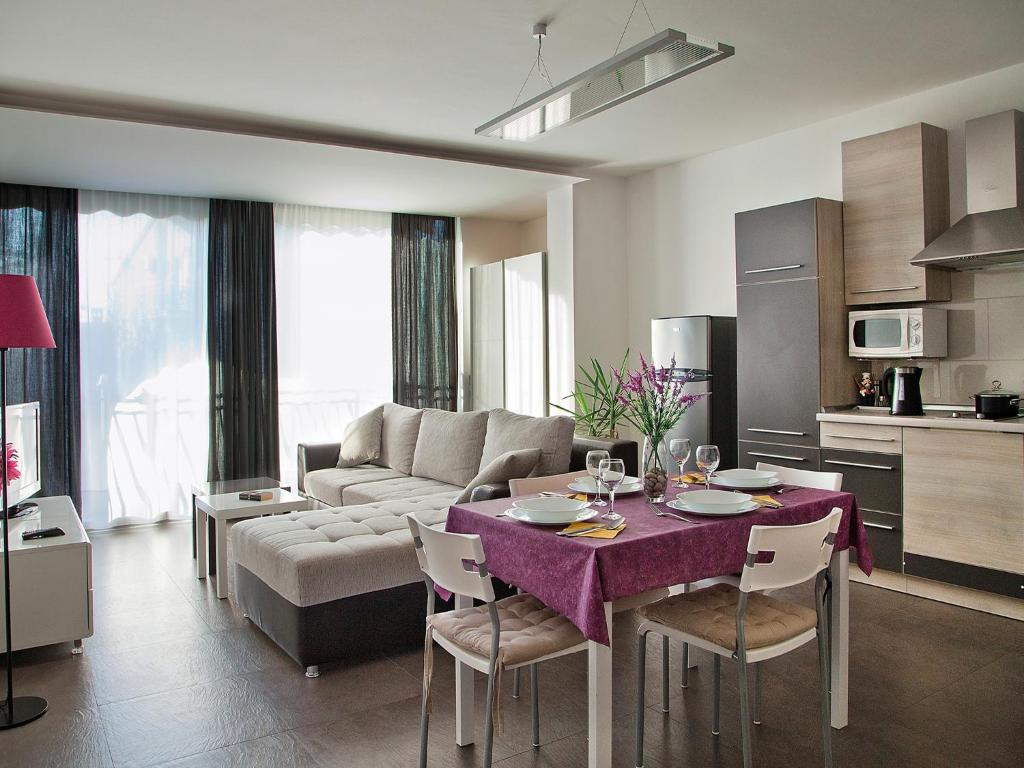 a living room with a table and a couch at Apartments Bozena in Poreč