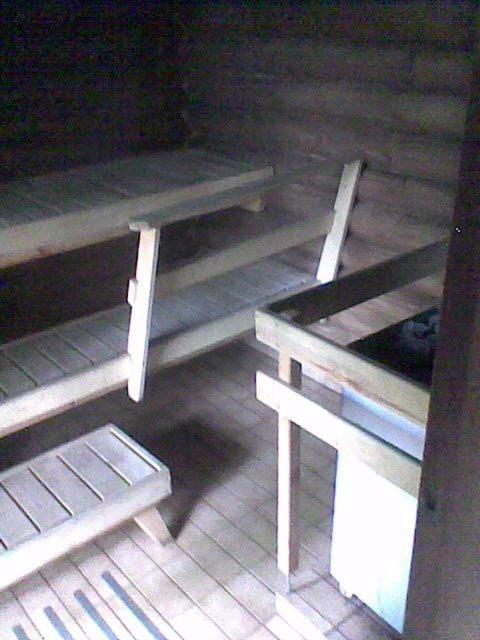 two picnic tables and a bench in a room at Cottage with private access to the sea, 6 beds! in Savitaipale