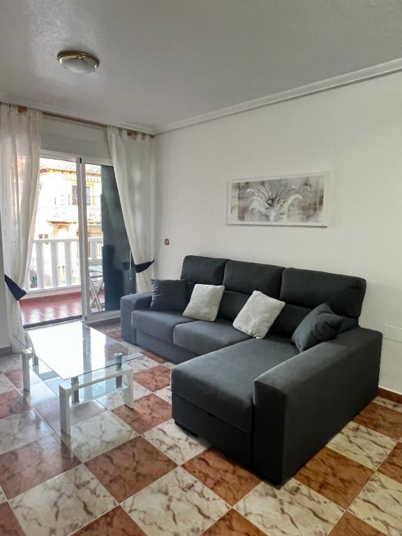 a living room with a couch and a glass table at Lima in Orihuela Costa