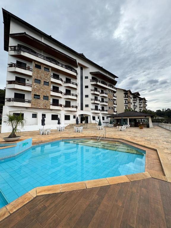 a large swimming pool in front of a building at Recanto Piemont in Serra Negra