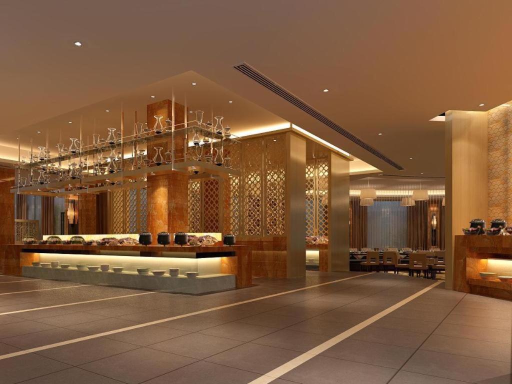 a lobby of a hotel with a chandelier at New Century Hotel Taizhou in Daidong