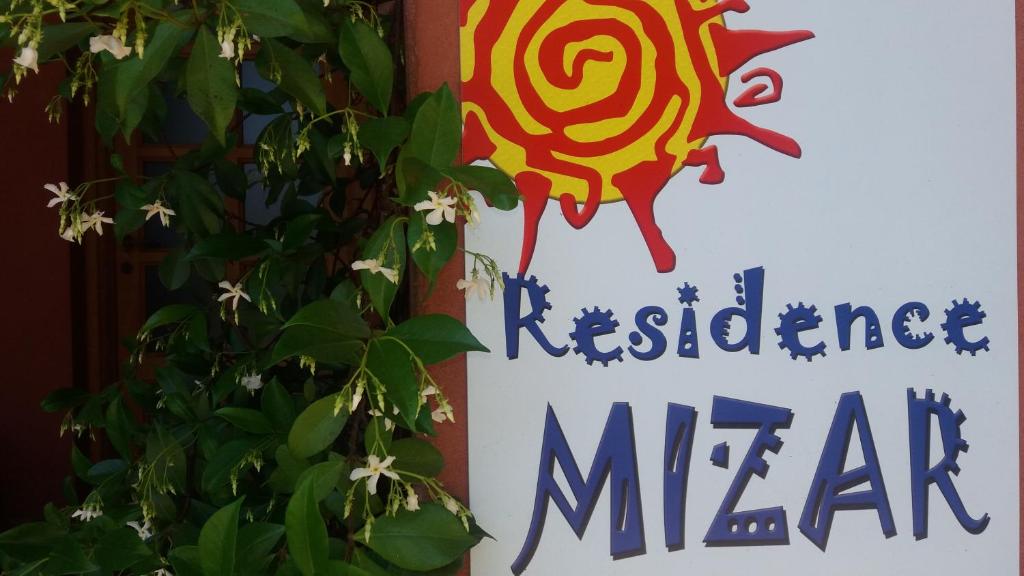 a sign for a restaurant near a plant at Residence Mizar 2 in Pietra Ligure