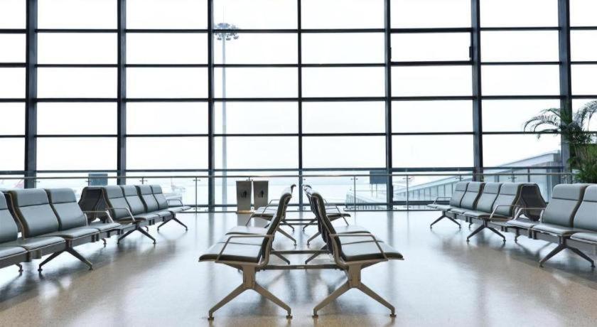 a room with chairs and a table in an airport at Argyle International Airport Hotel Shanghai in Shanghai