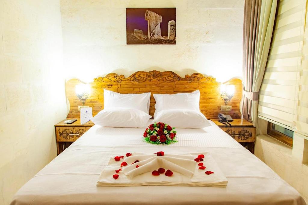 a hotel room with a bed with flowers on it at Şehrazat konağı in Urfa