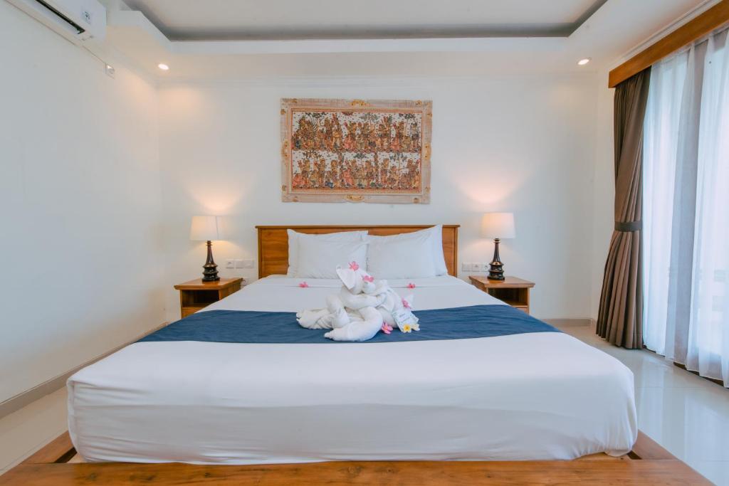 Postel nebo postele na pokoji v ubytování Puri Pandawa Resort