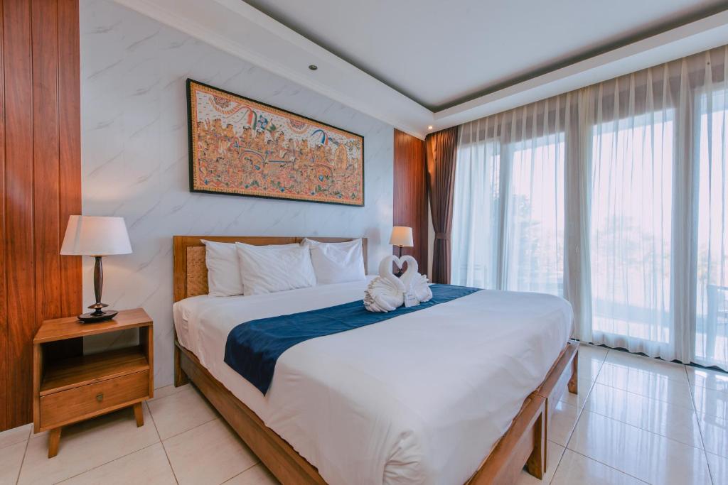 Postel nebo postele na pokoji v ubytování Puri Pandawa Resort