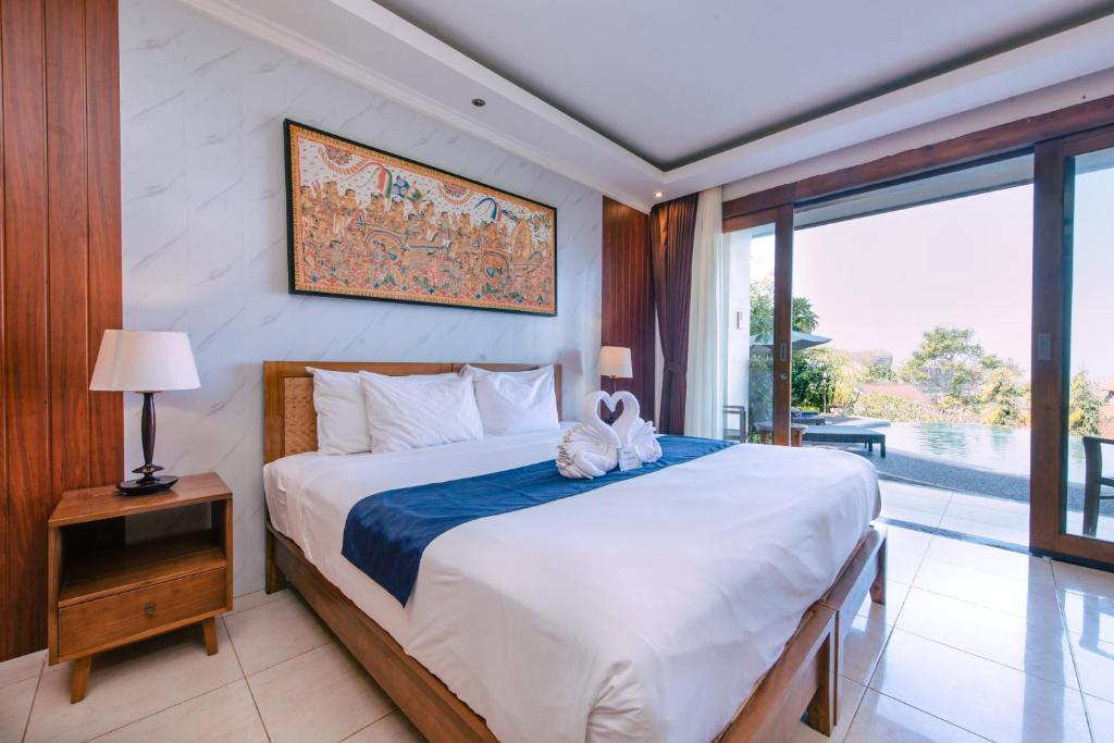 Postel nebo postele na pokoji v ubytování Puri Pandawa Resort