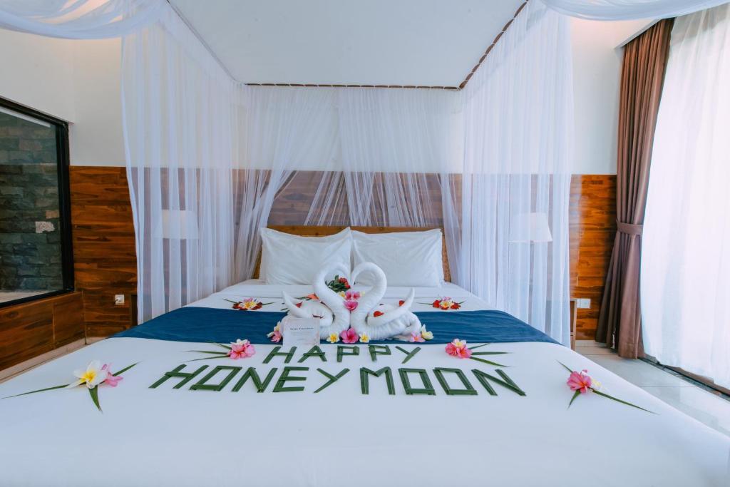 Postel nebo postele na pokoji v ubytování Puri Pandawa Resort